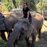 Traci riding an elephant