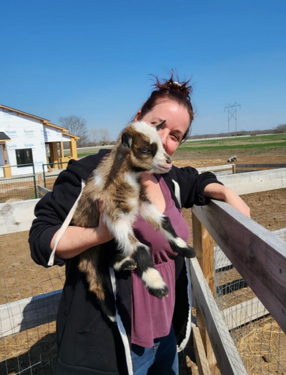 Traci holding a baby goat