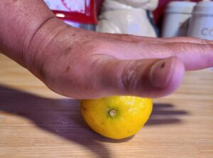 Rolling the lemon to release juice.